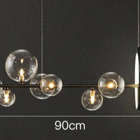 Moderne lineaire kroonluchter – glazen bollen en verlichte ring op zwart frame