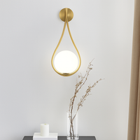 Design wandlamp met gouden LED en witte glazen bol Shadow